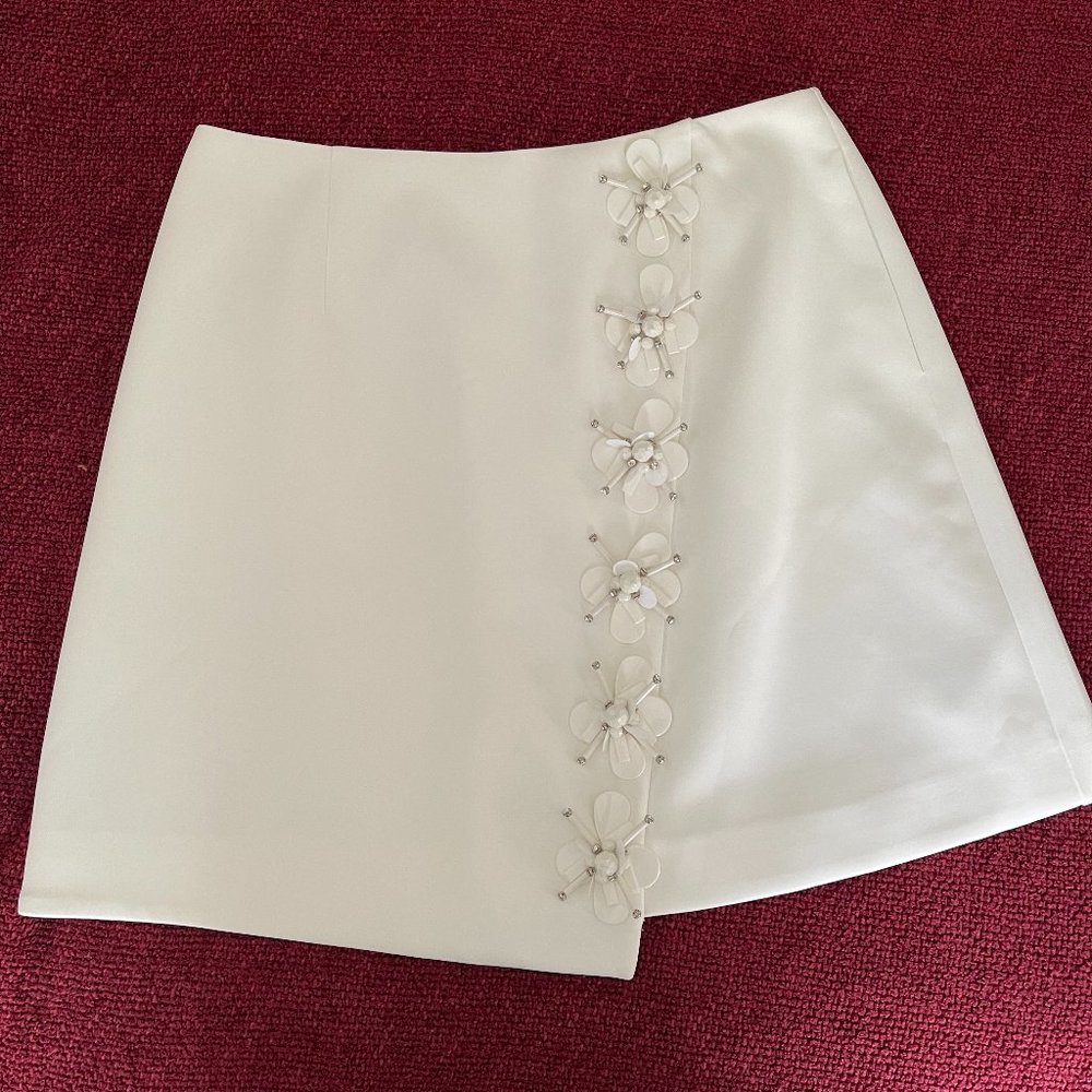 White mini skirt with jeweled flowers